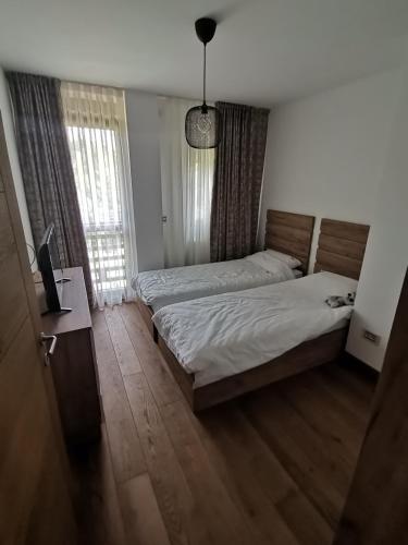 a bedroom with two beds and a television in it at V&Dj in Čajetina