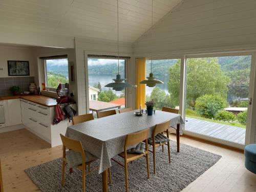 a kitchen and dining room with a table and chairs at Dyrhaug - hytte med utsikt over Krøderen in Noresund