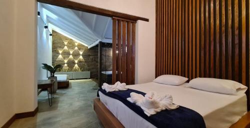 a bedroom with a bed with towels on it at All Natural Glamping in Copacabana