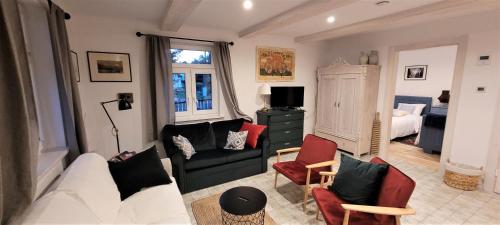 a living room with a couch and chairs at Chata 3 Drogi in Janów Podlaski