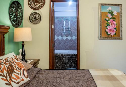 a bedroom with a bed and a door to a balcony at Casa Maricela B&B in San Miguel de Allende