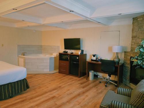 a hotel room with a bed and a bath tub at Wyndham Garden Warsaw in Warsaw