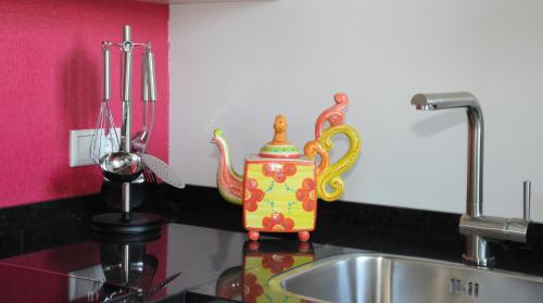 a kitchen counter with a sink and a pot on it at Hotel Abdijhof Thorn in Thorn