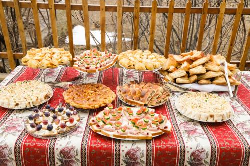 a table with many pizzas and other foods on it at Noravank B&B in Chʼiva