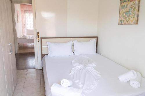 a bedroom with a white bed with towels on it at Apartment in Asprovalta in Asprovalta