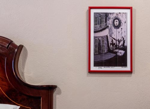 a picture hanging on a wall next to a chair at Casa Maricela B&B in San Miguel de Allende