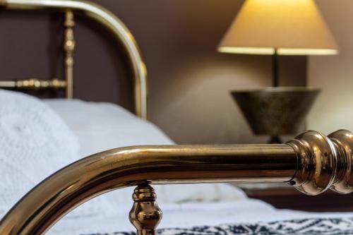 a close up of a bed frame with a lamp at Casa Maricela B&B in San Miguel de Allende