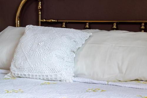 a white pillow sitting on top of a bed at Casa Maricela B&B in San Miguel de Allende