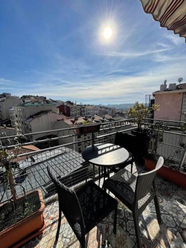 a patio with a table and chairs on a balcony at Faik Pasha Hotels Special Category Beyoglu Istanbul in Istanbul