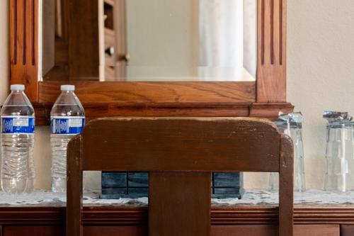 two bottles of water sitting on a table with a chair at Casa Maricela B&B in San Miguel de Allende