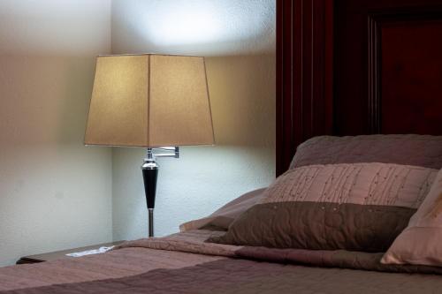 a lamp sitting on a table next to a bed at Casa Maricela B&B in San Miguel de Allende