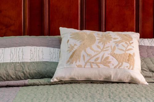 a pillow sitting on top of a bed at Casa Maricela B&B in San Miguel de Allende