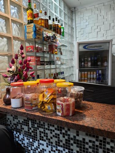 a kitchen counter with food items on top of it at Hotel Vila Maria in Sao Paulo