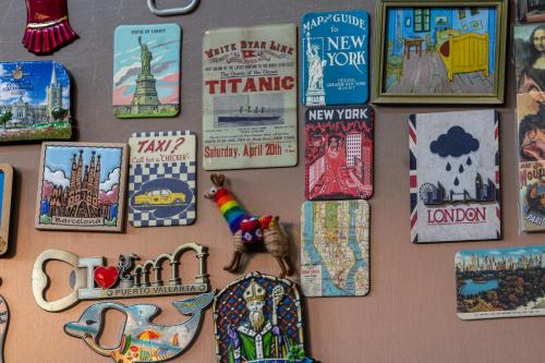 a wall filled with lots of different types ofhemera at Casa Maricela B&B in San Miguel de Allende