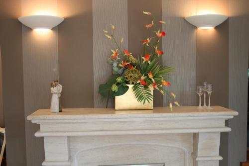 a bouquet of flowers sitting on top of a fireplace at Ayrs and Graces - Luxury Bed and Breakfast in Ayr