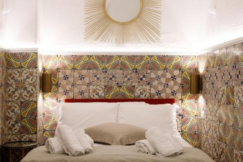 a bedroom with a bed with two towels on it at Qasar Luxury Suite - in Capri's Piazzetta in Capri