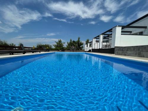 a swimming pool in front of a building at Relax zone - Apartmani La ISA in Varaždin Breg