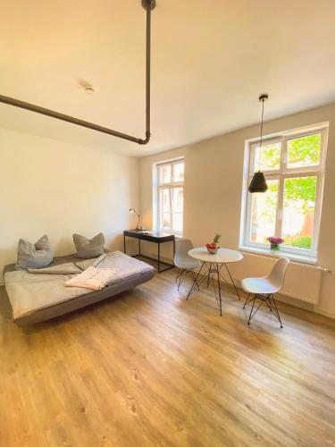 a bedroom with a bed and a table and chairs at Studiowohnung 1 in Buxtehude in Buxtehude