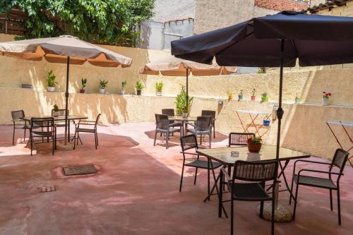 a patio with tables and chairs and umbrellas at Apartment in Asprovalta in Asprovalta