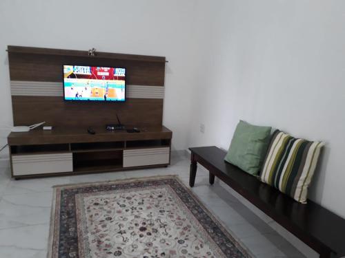 Uma televisão e/ou sistema de entretenimento em Casa Aconchego Guarujá