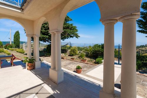 a view from the porch of a house with columns at Domus Mare Cilento in Agropoli