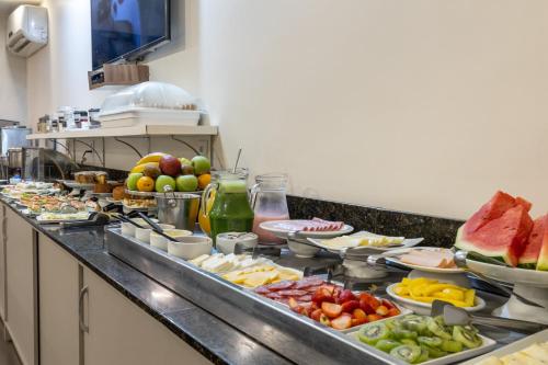 a buffet line with many different types of food at Hotel Dom Rafael Premium in Santa Maria