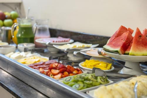 a buffet with many different types of fruits and vegetables at Hotel Dom Rafael Premium in Santa Maria