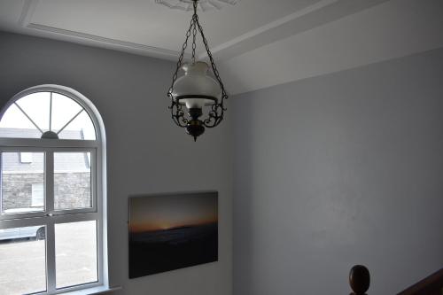 a chandelier hanging in a room with a window at Aran View Holiday Homes Doolin- home no1 - Ocean View in Doolin
