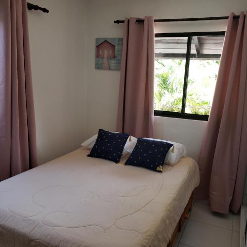 a small bed in a room with a window at Lovely location , right downtown Puerto Plata in San Felipe de Puerto Plata