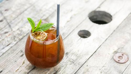 a drink sitting on a wooden table with a spoon at Ungru Guesthouse in Suuresadama