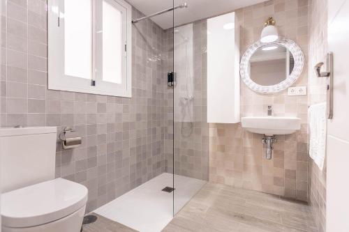 a bathroom with a toilet and a sink and a mirror at Maravilloso loft dúplex casco histórico in Seville