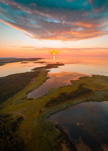 an aerial view of a sunset over a river at Ungru Guesthouse in Suuresadama