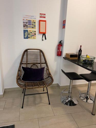 a rattan chair with a pillow on it next to a counter at Esmeralda Holidays Apartments in Funchal