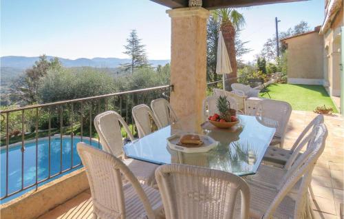 a table and chairs on a balcony with a pool at Amazing Home In Le Tignet in Le Tignet