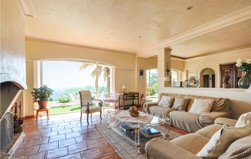a living room with a couch and a table at Amazing Home In Le Tignet in Le Tignet