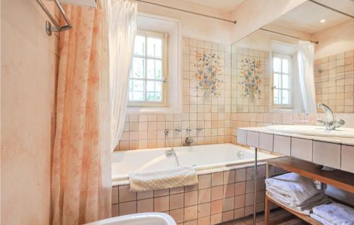 a bathroom with a tub and a sink at Lovely Home In Le Tignet With Outdoor Swimming Pool in Le Tignet