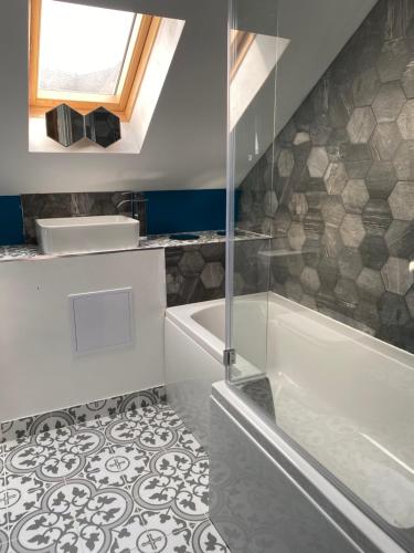 a bathroom with a shower and a tub and a sink at Stratford House in Stratford-upon-Avon