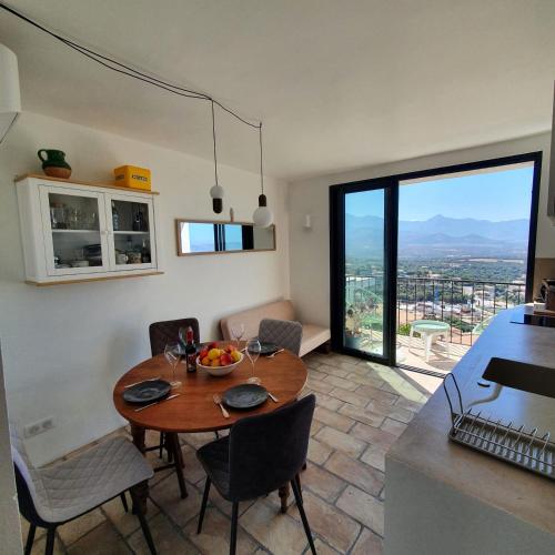 a kitchen and dining room with a table in a kitchen at A Casarella in Lumio