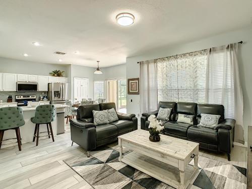 a living room with a couch and a table at Luxury Family Villa Pool Hot Tub Close to Disney in Orlando