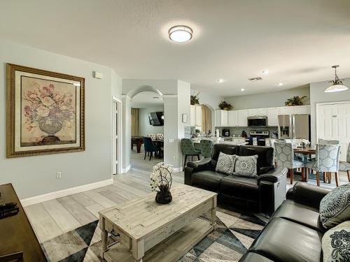 a living room with a couch and a table at Luxury Family Villa Pool Hot Tub Close to Disney in Orlando