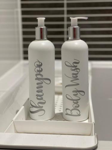 two bottles ofodorizers are sitting on a sink at White house in Milton Keynes