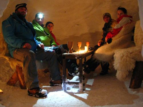 a group of people sitting in a room with a table at Conacul Ursului in Cumpăna