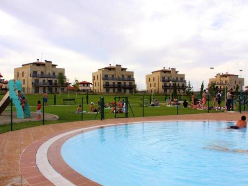 a large pool in a park with people playing at Belvilla by oyo Campo de Golf in Cirueña