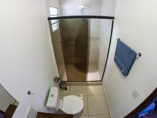 a small bathroom with a shower and a toilet at Fauna in Praia do Bananal
