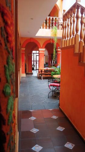 a hallway with tables and chairs in a building at Hotel Boutique Casa Montalvo Cuenca in Cuenca