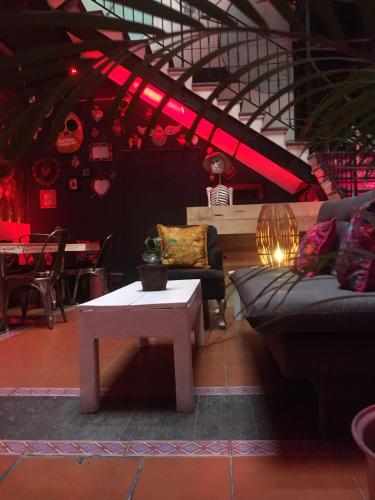 a living room with a couch and a table at Hostal Regina Down Town Mexico City in Mexico City