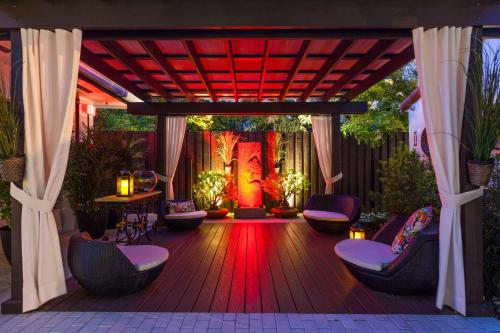 a wooden deck with chairs and a red light at Bars B&B South Beach Hotel in Miami Beach