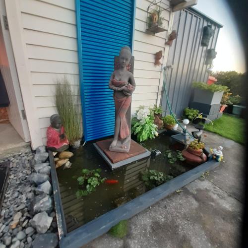 a statue in front of a house with a garden at rooms with a view in Haywards