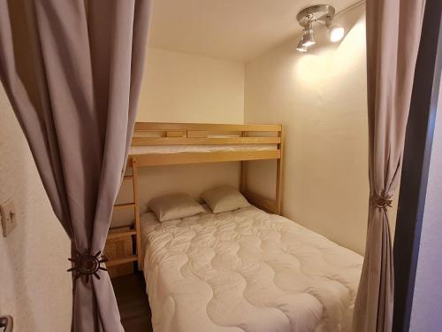 a small bedroom with a bunk bed and a curtain at Studio Les Deux Alpes, 1 pièce, 4 personnes - FR-1-348-253 in Les Deux Alpes