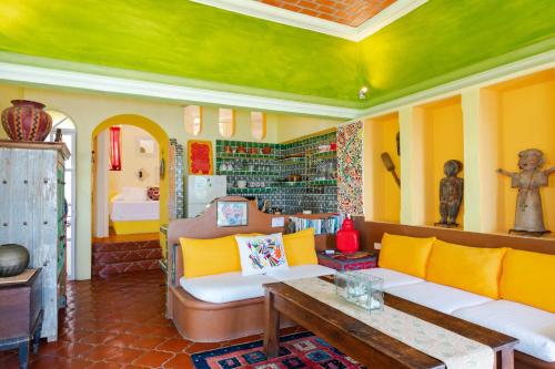 a living room with a couch and a table at Villas Jardin Del Mar in Cruz de Huanacaxtle
